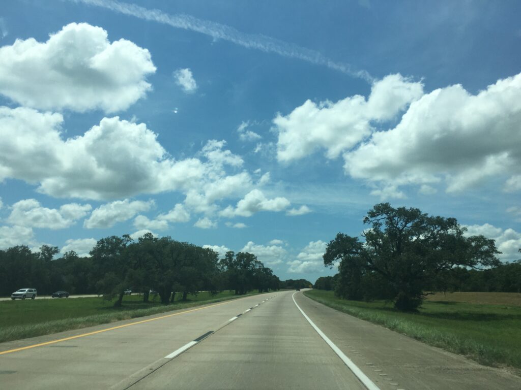 On the road to Surfside fluffy clouds and jet trails