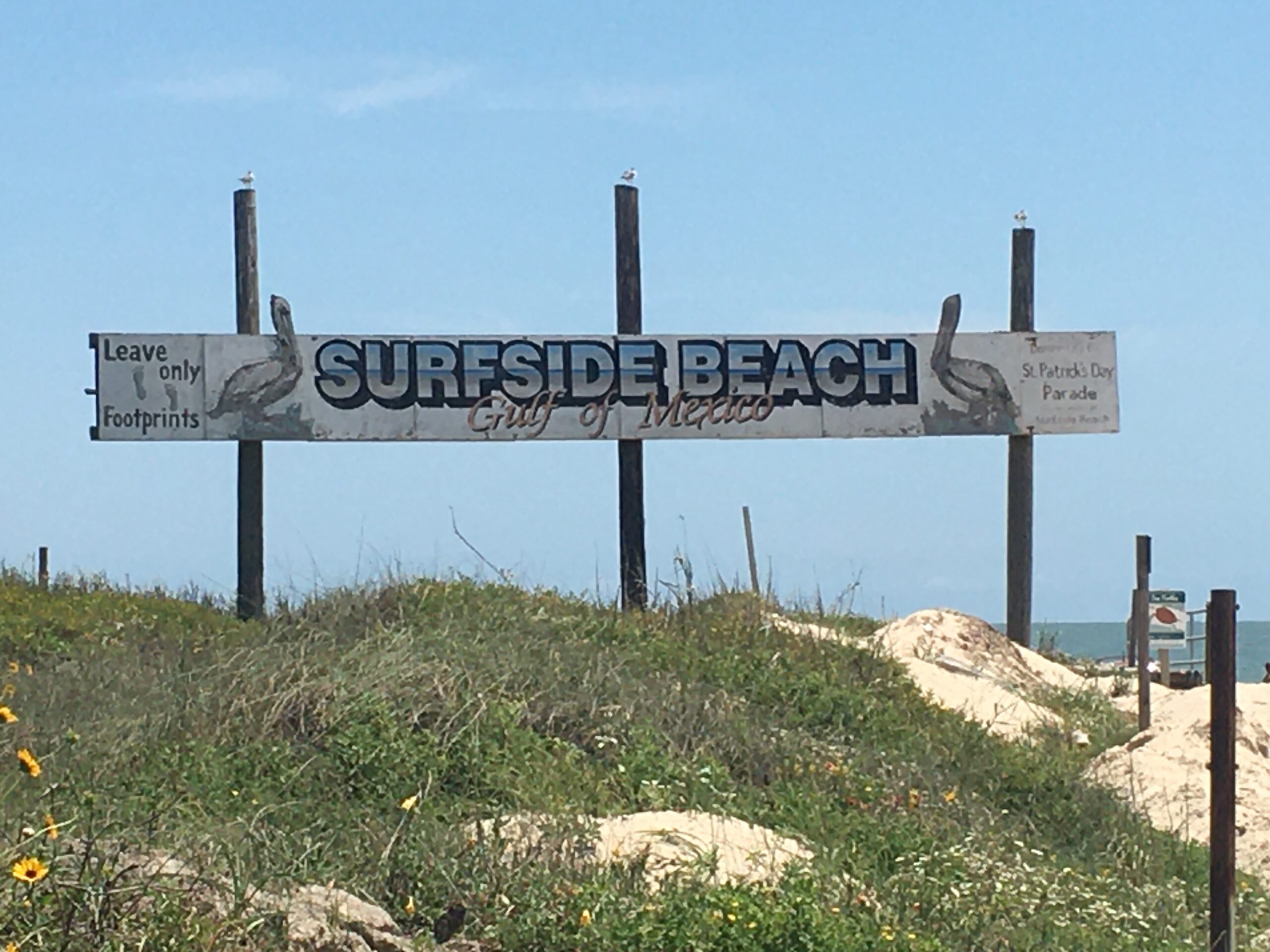 Surfside Beach Texas on the Gulf of Mexico sign on the dunes