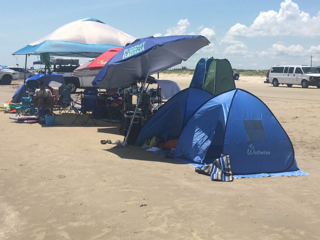 People spending the day at Surfside Beach Texas with tents