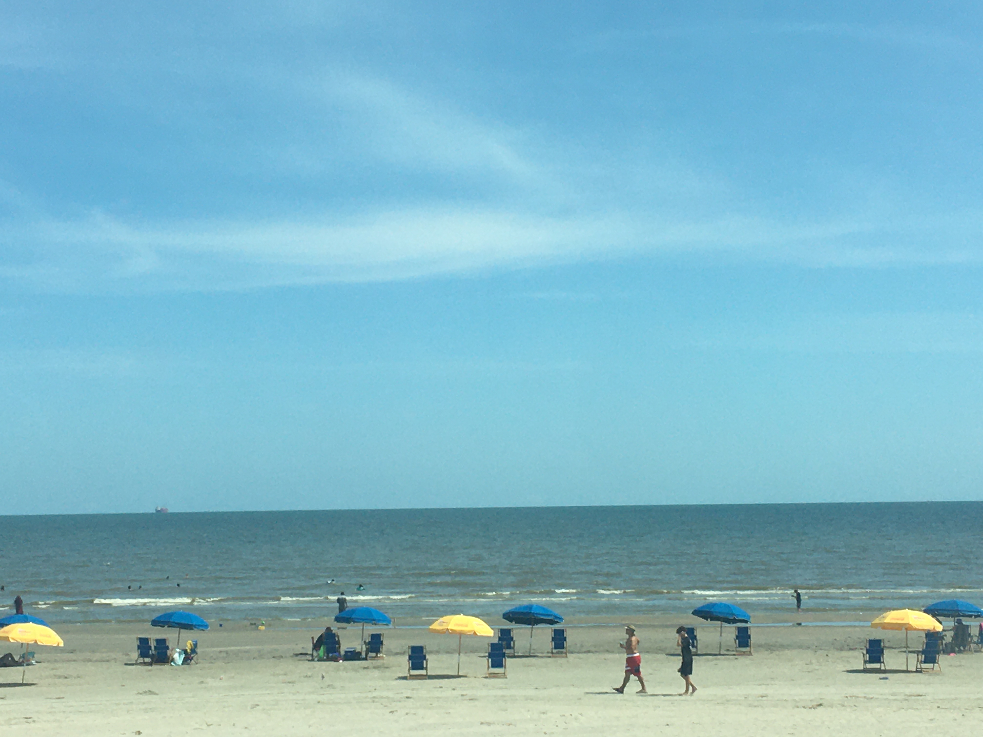Socially distanced swimmers and sunbathers at Surfside Beach Texas