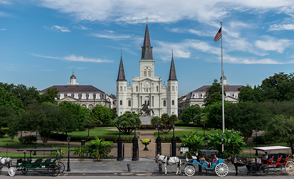 St. Louis Basilica sits at the back of Jackson Square next to the Cabildo museum and near the New Orleans French Market